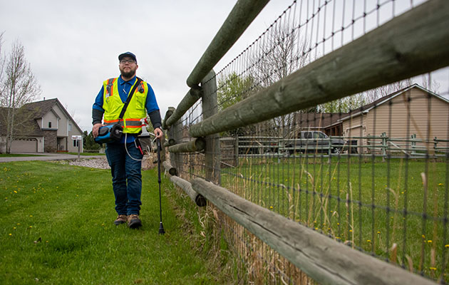 An contractor with Heath Consultants performs a gas leak survey.